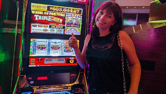 woman standing near slots machine